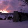 Grey Mare Hut at sunrise with the weather moving in